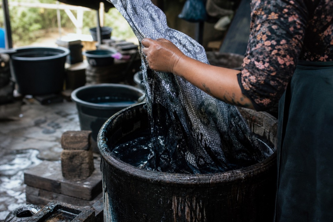 Batik being dyed by hand in a Yogyakarta workshop